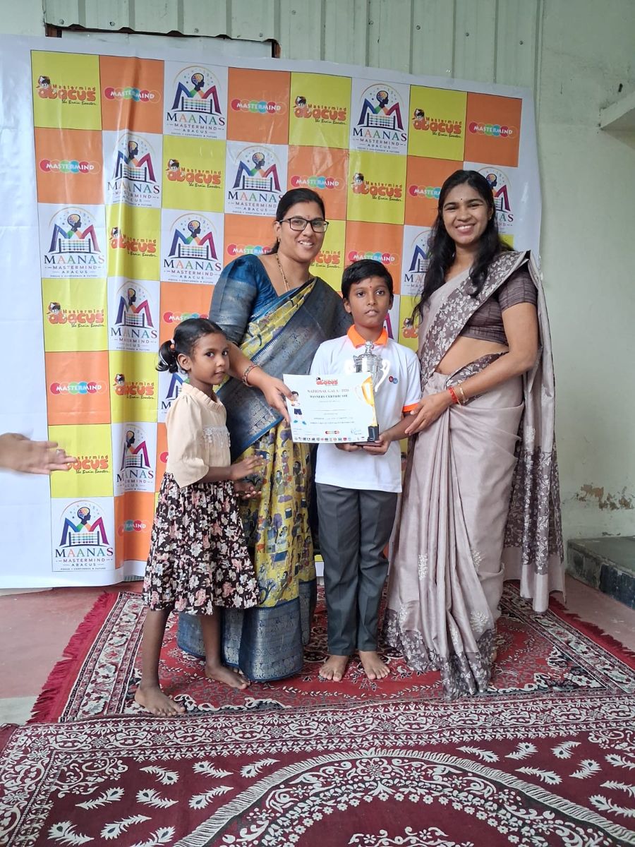 Our teacher with a student holding a trophy