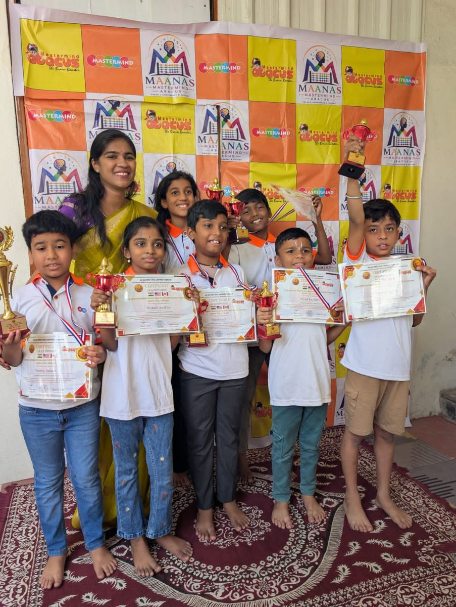 Maanas students holding their trophies and certificates